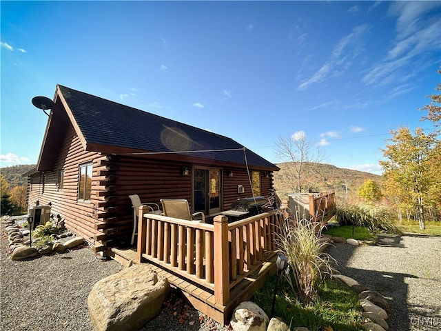 rear view of property with a deck with mountain view