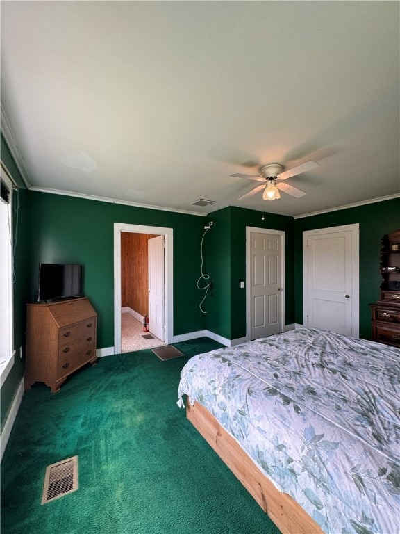 carpeted bedroom with ceiling fan and crown molding