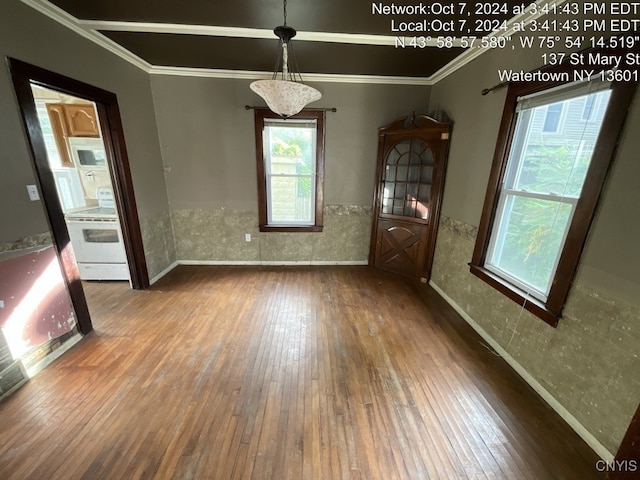 unfurnished dining area featuring wood-type flooring and ornamental molding