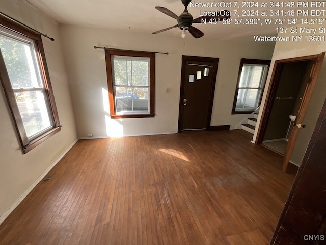 foyer with dark hardwood / wood-style flooring and ceiling fan