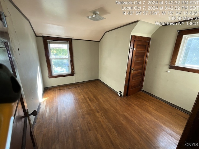 additional living space featuring hardwood / wood-style flooring and vaulted ceiling