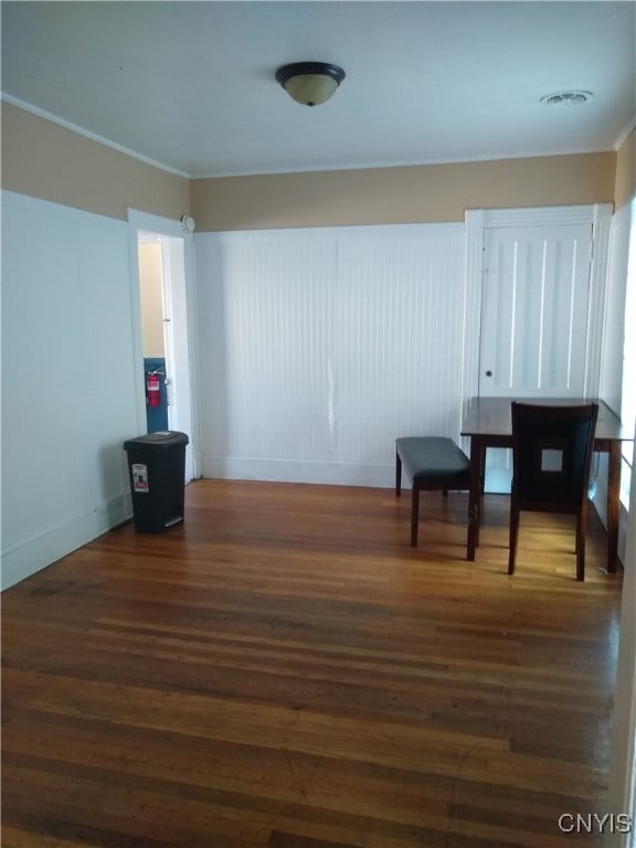 interior space with crown molding and dark hardwood / wood-style flooring