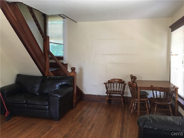 sitting room with dark wood-type flooring and a wealth of natural light