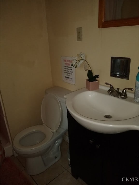 bathroom featuring tile patterned flooring, vanity, and toilet