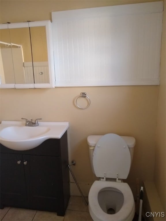 bathroom featuring tile patterned floors, toilet, and vanity