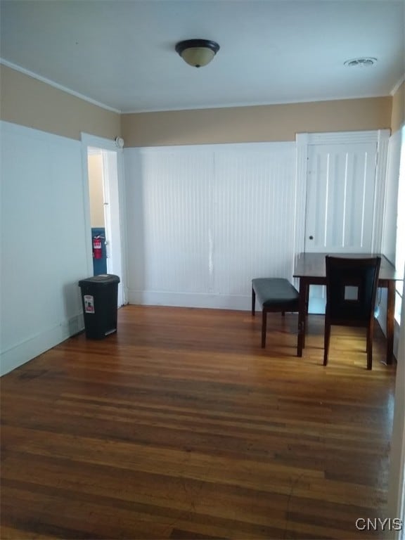 interior space with ornamental molding and dark hardwood / wood-style floors