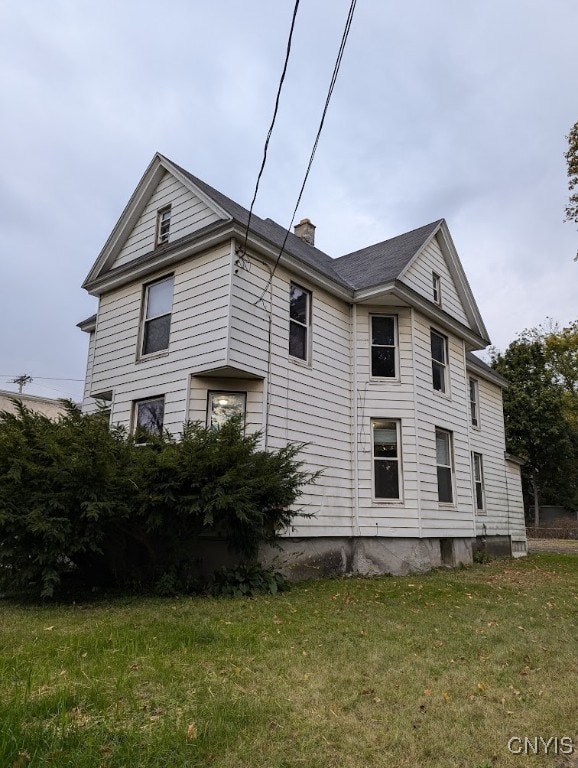 view of home's exterior with a lawn