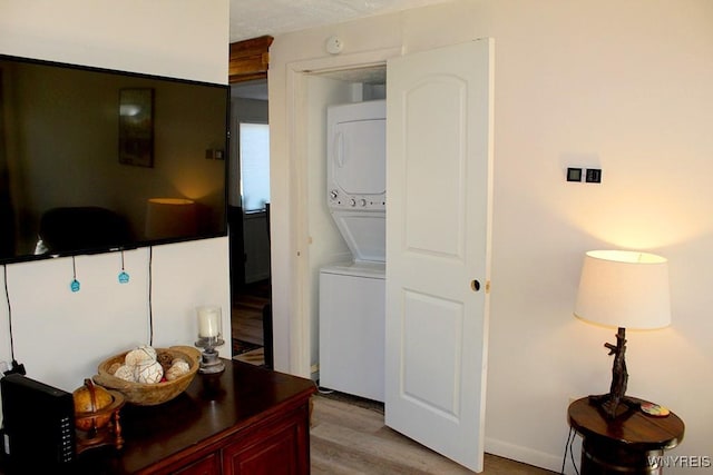 interior space with light hardwood / wood-style floors and stacked washer and dryer