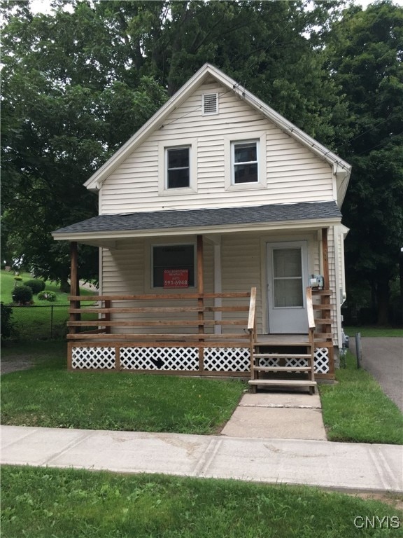 view of front of home with a front yard and a porch