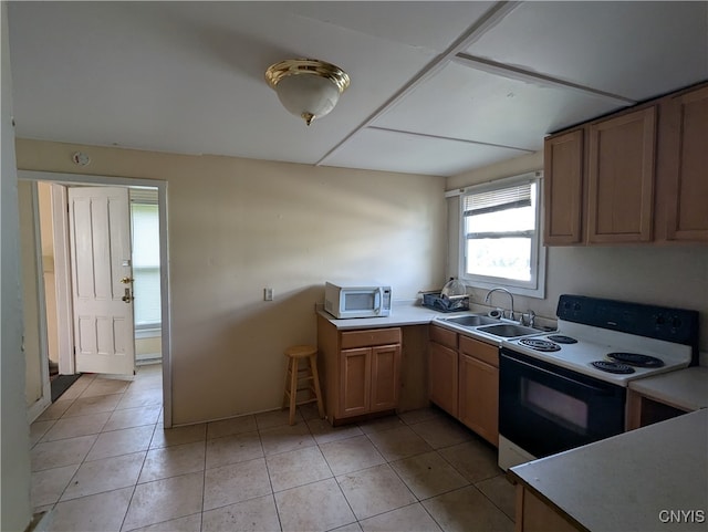 kitchen featuring light tile patterned flooring, white appliances, and sink