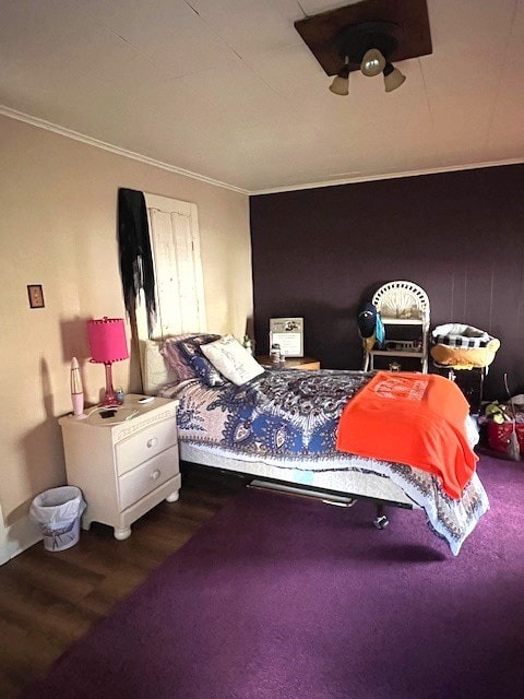 bedroom with crown molding and wood-type flooring