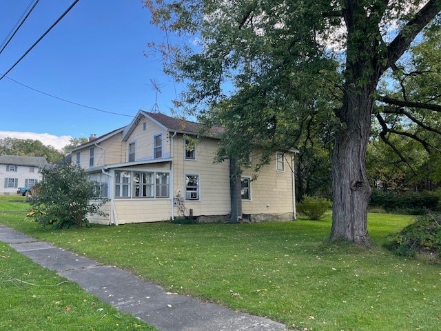 view of side of property with a yard