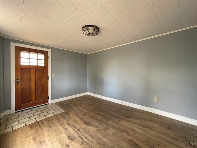 foyer entrance featuring hardwood / wood-style flooring and ornamental molding