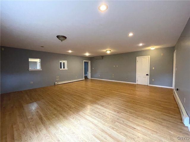 spare room with light hardwood / wood-style floors and baseboard heating