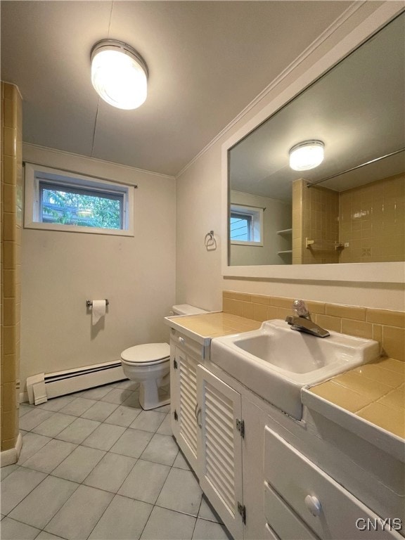 bathroom featuring vanity, a baseboard heating unit, tile patterned floors, decorative backsplash, and toilet