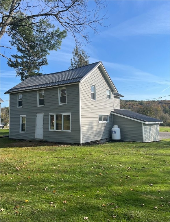 back of property with a lawn