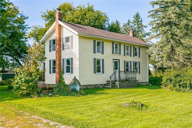 colonial-style house with a front yard