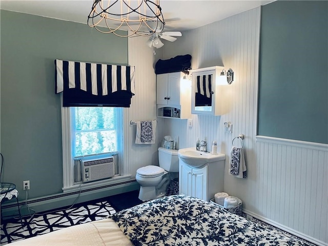 bathroom featuring ceiling fan, cooling unit, vanity, a baseboard heating unit, and toilet