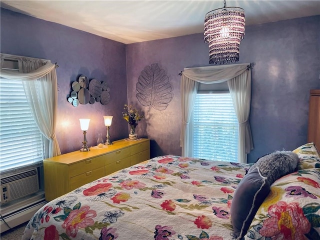 bedroom with an inviting chandelier and a baseboard heating unit