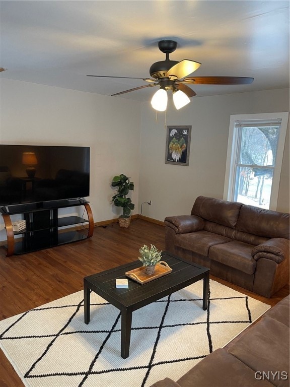 living room with ceiling fan and light hardwood / wood-style flooring