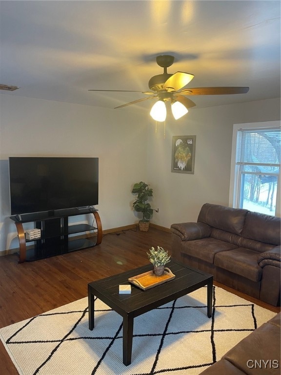 living room featuring ceiling fan and light hardwood / wood-style floors