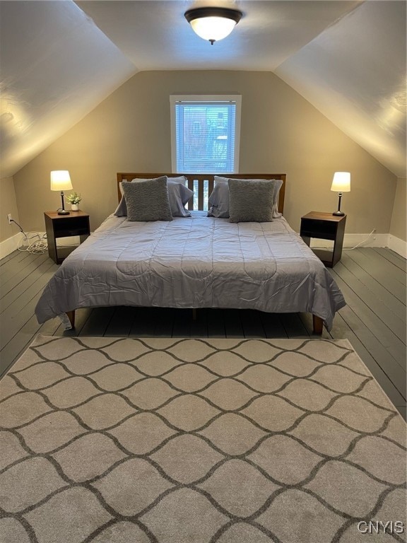 bedroom featuring hardwood / wood-style flooring and vaulted ceiling