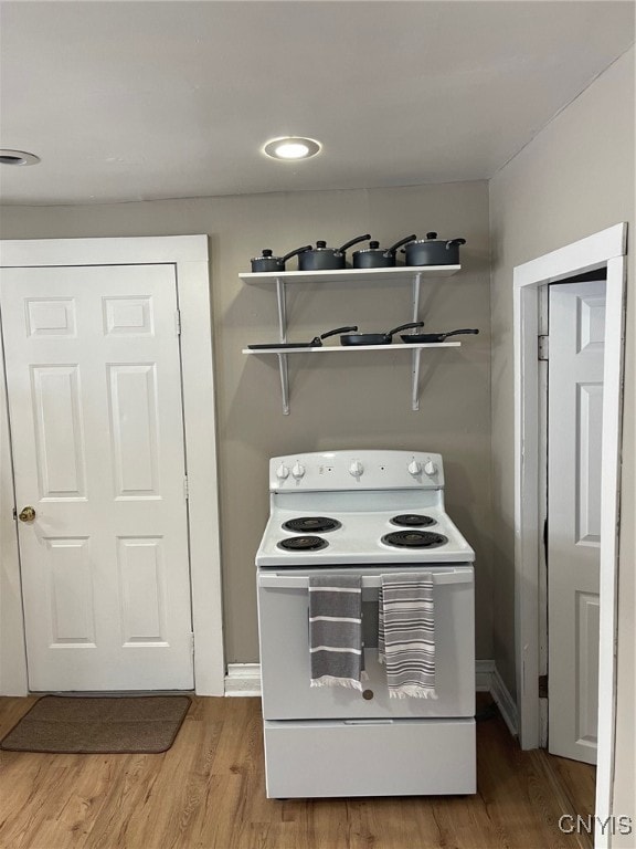 kitchen featuring hardwood / wood-style floors and white electric stove