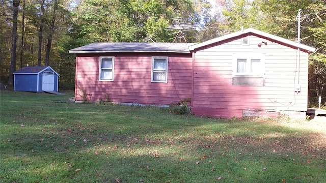 view of home's exterior with a storage shed and a lawn