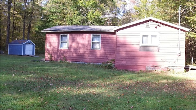 view of home's exterior featuring a storage shed, an outdoor structure, and a lawn