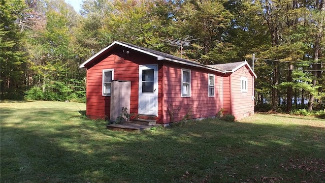 view of outbuilding with a yard