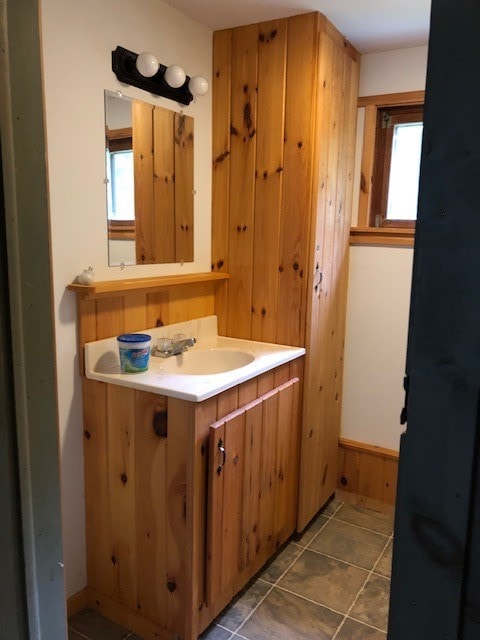 bathroom with vanity, tile patterned flooring, and a healthy amount of sunlight