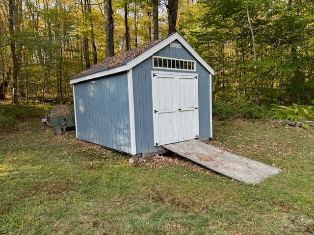 view of outbuilding featuring a lawn