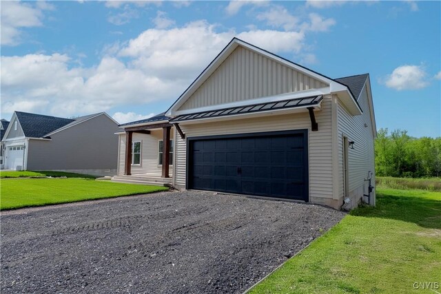 LOT58 Chillingham Way, Lysander, NY 13027 - view of front of house featuring board and batten siding, an attached garage, a front yard, and gravel driveway