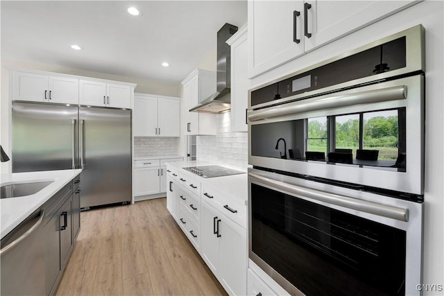 LOT58 Chillingham Way, Lysander, NY 13027 - kitchen featuring appliances with stainless steel finishes, wall chimney range hood, light countertops, white cabinetry, and recessed lighting