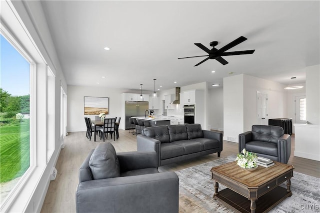 LOT58 Chillingham Way, Lysander, NY 13027 - living area with light wood-style floors, ceiling fan, recessed lighting, and baseboards