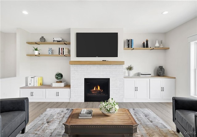 LOT58 Chillingham Way, Lysander, NY 13027 - living area featuring light wood finished floors, recessed lighting, and a brick fireplace