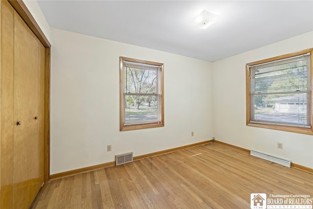 unfurnished bedroom featuring a closet and light hardwood / wood-style flooring