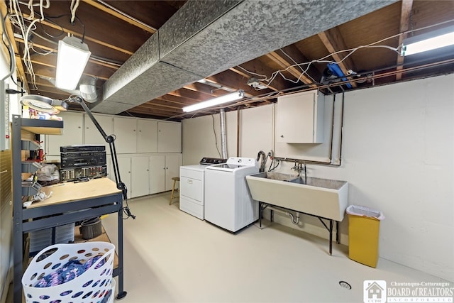 washroom featuring cabinets, separate washer and dryer, and sink