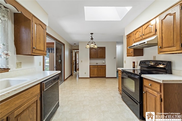 kitchen with pendant lighting, a skylight, black appliances, and a chandelier