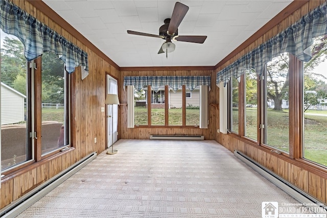 unfurnished sunroom featuring ceiling fan and a baseboard heating unit