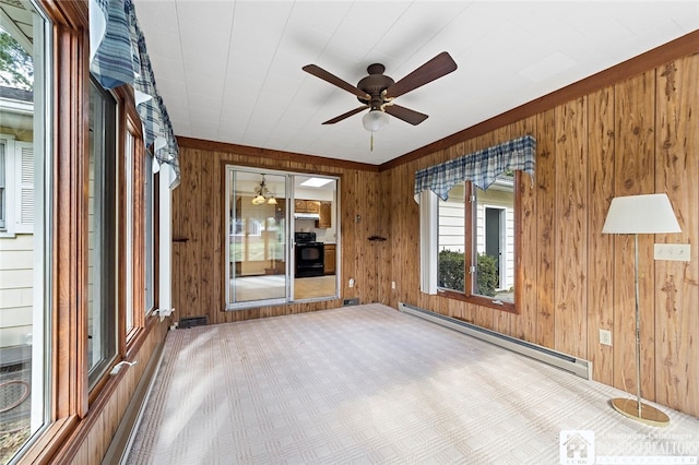 empty room featuring ceiling fan, a baseboard radiator, and wooden walls