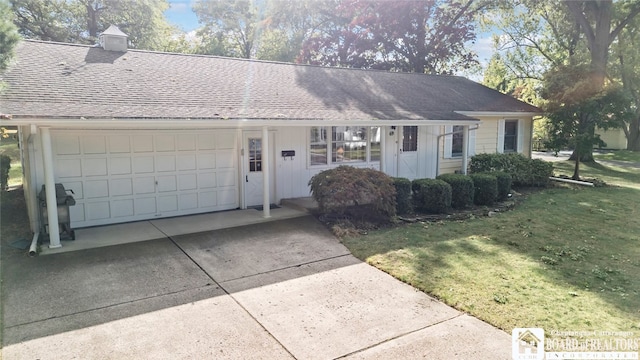 single story home featuring a garage and a front yard