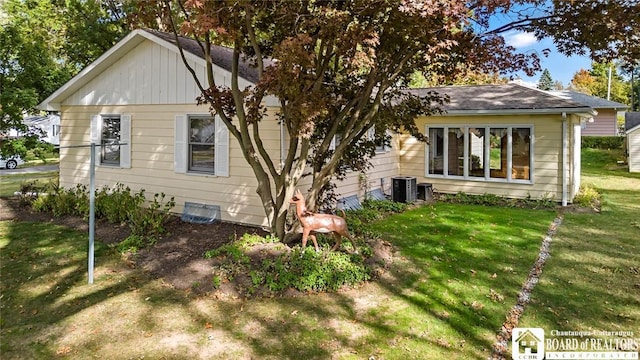 69 Cottage St Unit S, Pomfret, NY 14063 - view of side of home featuring a lawn, a shingled roof, and cooling unit