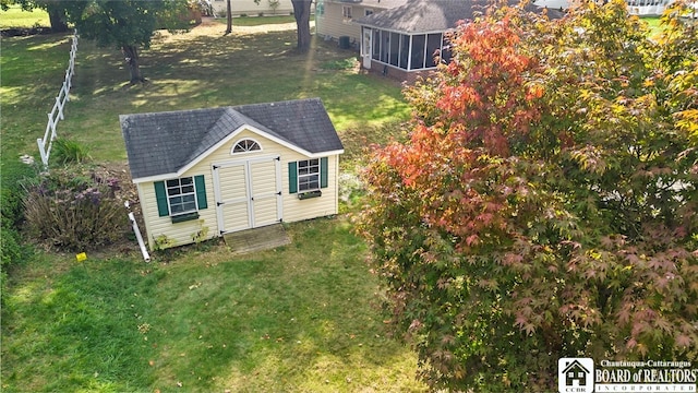 exterior space with a yard and a sunroom