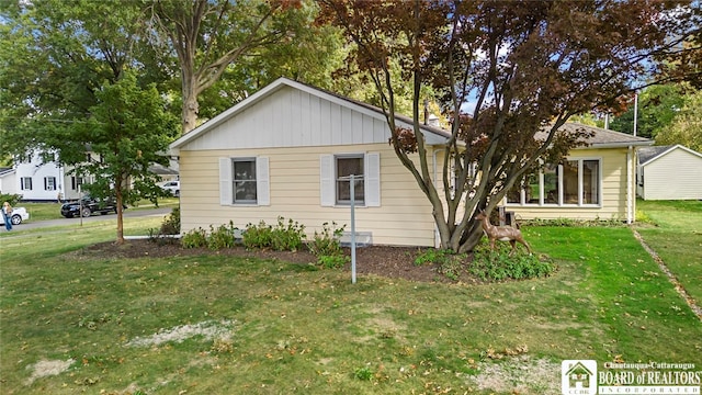 view of side of home with a lawn