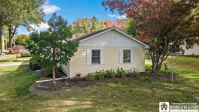 69 Cottage St Unit S, Pomfret, NY 14063 - view of property exterior featuring a lawn and board and batten siding