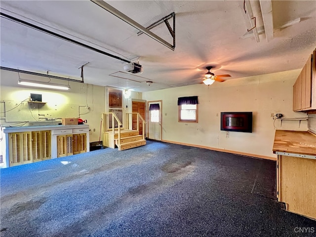 garage with a garage door opener and ceiling fan