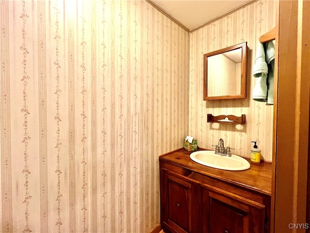 bathroom featuring crown molding, vanity, and a textured ceiling