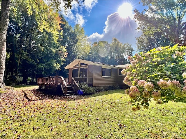 exterior space featuring a deck and a lawn