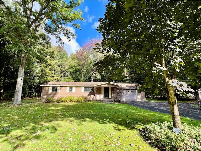 single story home featuring a garage and a front yard